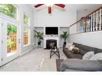 Bright living room boasts a fireplace, vaulted ceilings, and an abundance of natural light at 3034 Winfred Dell Ln, Cary, NC 27511