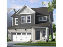 Charming two-story home featuring a brick garage, gray siding, and a welcoming front porch at 309 Beacon Dr, Pittsboro, NC 27312