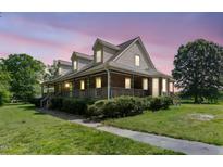 Charming two-story brick home with a large wrap-around porch and dormer windows at 319 Knox Rd, Gibsonville, NC 27249