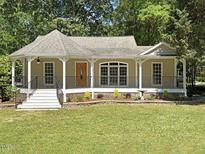 Charming one-story home with a welcoming front porch and well-manicured lawn at 4220 Hope Valley Road Rd, Durham, NC 27707