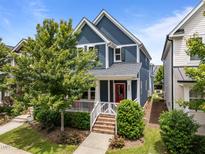 Charming two-story home with blue siding, a red front door, a cozy front porch and landscaped front yard at 450 Granite Mill Blvd, Chapel Hill, NC 27516