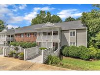 Inviting condo with a covered porch, walkway, and well-maintained landscaping on a sunny day at 501 Gooseneck Dr # B2, Cary, NC 27513