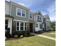 Charming townhomes with stone accents, multiple windows and beautifully landscaped front yards at 6447 Granite Quarry Dr, Raleigh, NC 27610