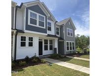 Charming new two-story home with a well-manicured lawn and sidewalk leading to the front door at 6449 Granite Quarry Dr, Raleigh, NC 27610