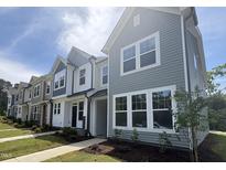 Row of new construction townhomes with varied siding, landscaping, and sidewalks at 6451 Granite Quarry Dr, Raleigh, NC 27610