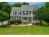 Charming two-story home with a well-manicured lawn and inviting front porch at 8140 Consella Way, Willow Springs, NC 27592