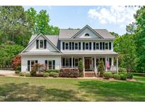 Beautiful two-story home with a welcoming front porch and a well-manicured lawn at 8536 Wolverton Fields Dr, Wake Forest, NC 27587