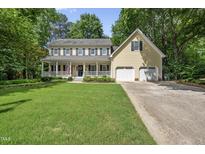 Charming two-story traditional home with a welcoming front porch and well-manicured lawn at 1007 Surry Dale Ct, Apex, NC 27502
