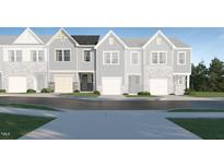 Charming new construction townhomes featuring craftsman-style architectural details, garages, and professional landscaping at 1125 Weavers Trace Dr, Zebulon, NC 27597