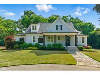 Charming single-Gathering home with a well-manicured lawn and stone pathway leading to the front porch at 125 Lord Ashley Rd, Raleigh, NC 27610