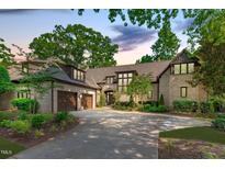 Stunning two-story brick home featuring a spacious driveway and a two-car garage at 1305 Queensferry Rd, Cary, NC 27511