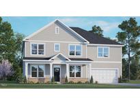 Charming two-story home with a welcoming front porch and attached two-car garage at 133 Gilmer St, Fuquay Varina, NC 27526