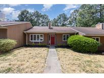 Charming single-story home with a red front door, well-maintained landscaping, and a cozy curb appeal at 139 Hollyhock Ct, Durham, NC 27713