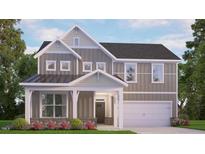 Charming two-story home boasting gray siding, white trim, and a welcoming covered front porch at 147 Gilmer St, Fuquay Varina, NC 27526