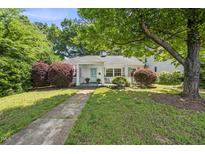 Charming home featuring a quaint porch, well-manicured landscaping, and inviting curb appeal at 1812 Hilton St, Raleigh, NC 27608