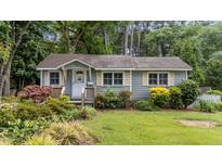 Charming single-story home featuring a lush, landscaped front yard and inviting entrance at 205 W Oak Ave, Wake Forest, NC 27587