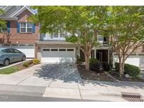 Charming townhome with brick and siding, featuring a two-car garage and landscaped front yard at 2082 Weston Green Loop Loop, Cary, NC 27513