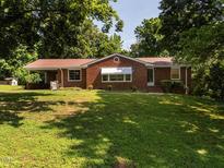 Charming single-story brick home with a well-manicured lawn and mature trees at 2434 Morningside Dr, Burlington, NC 27217