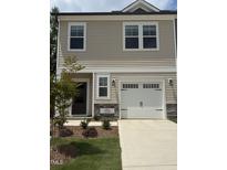 Charming two-story home features a front-entry garage, neutral siding, and a well-maintained lawn and landscaping at 253 Hank Way, Angier, NC 27501