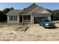 Charming single-story home with a covered front porch and an attached garage at 2760 Rains Mill Rd, Princeton, NC 27569