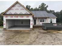 Exterior of a new home under construction with an attached garage and a dumpster for waste removal at 2776 Rains Mill Rd, Princeton, NC 27569