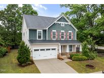 Two-story home featuring a two-car garage, neutral siding and colorful accent shutters at 2855 Wilkes Lake Dr, Fuquay Varina, NC 27526