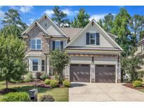 Beautiful two-story home with stone and siding, a two-car garage, and well-manicured landscaping at 3108 Lawson Walk Way, Rolesville, NC 27571