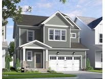 Charming two-story home with a covered porch, gray siding, white trim and a two car garage at 335 Beacon Dr, Pittsboro, NC 27312