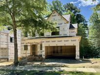 New construction home features a two-car garage, covered entryway, and is surrounded by mature trees in a desirable location at 3824 Coach Lantern Ave, Wake Forest, NC 27587