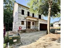 New construction featuring an unfinished exterior, showing building wrap and exposed framework on a sunny day at 3824 Coach Lantern Ave, Wake Forest, NC 27587