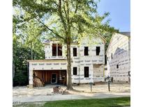 New construction home featuring unfinished exterior and a tree providing shade in the front yard at 3828 Coach Lantern Ave, Wake Forest, NC 27587