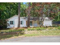 Charming single story home featuring a manicured front yard, inviting front porch, and lovely trees at 3916 W Allen, Raleigh, NC 27603