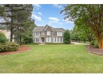 Beautiful two-story home with stone accents, a well-manicured lawn, and mature trees enhancing its curb appeal at 50 Pebble Creek Dr, Franklinton, NC 27525