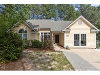 Charming home featuring an inviting walkway, mature landscaping, and a well-maintained front yard at 5301 Northpines Dr, Raleigh, NC 27610