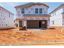 New construction home exterior showcasing Tyvek HomeWrap and brick detail at 828 Ottawa Dr, Garner, NC 27529