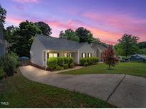 Charming single-story home featuring a well-manicured lawn, concrete driveway and mature landscaping at 8312 Bellingham Cir, Raleigh, NC 27615