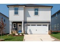 Charming two-story home featuring a white garage door, gray accents, and a well-maintained lawn at 832 Ottawa Dr, Garner, NC 27529