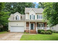 Charming two-story home featuring a well-manicured front yard and an attached two-car garage at 933 Richland Ridge Dr, Wake Forest, NC 27587
