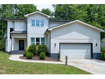 Charming two-story home featuring a two-car garage, complemented by well-manicured landscaping at 1003 E Sterlington Pl, Apex, NC 27502