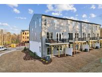 View of the exterior with balconies of these newly built townhomes ready for new owners at 10518 Pleasant Branch Dr # 38, Raleigh, NC 27614