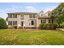 Charming two-story home boasts manicured lawn, dormer windows, and classic architectural details at 111 Gingergate Dr, Cary, NC 27519