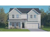 Charming two-story home featuring board and batten siding, a covered front porch, and an attached two-car garage at 128 Gilmer St, Fuquay Varina, NC 27526