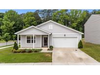 Charming single-Gathering home with gray siding, attached garage, and well-manicured front lawn and landscaping at 1401 Justice Union Ct, Raleigh, NC 27604