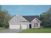 Charming home with a symmetrical elevation, 2-car garage, stone details, and inviting curb appeal at 148 Gilmer St, Fuquay Varina, NC 27526