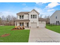 Charming two-story home with a two car garage, cozy front porch, and well-manicured lawn at 169 Horseshoe Pl # 55, Angier, NC 27501