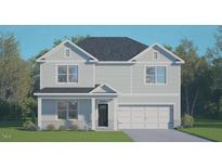 Charming two-story home features a classic design, attached two-car garage, and beautifully maintained landscaping at 177 Gilmer St, Fuquay Varina, NC 27526