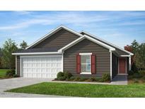 Charming single-story home featuring a classic design with a two-car garage and well-manicured landscaping at 223 Norman Ave, Lillington, NC 27546