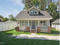 Charming single-Gathering home featuring a welcoming front porch and well-maintained lawn at 2620 Holloway St, Durham, NC 27703