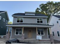 Charming two-story home with gray siding, covered porch, and a stylish modern design at 2658 Lawndale Ave, Durham, NC 27705