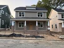 Charming two-story home with a covered porch and brick accents, offering a welcoming curb appeal at 2658 Lawndale Ave, Durham, NC 27705